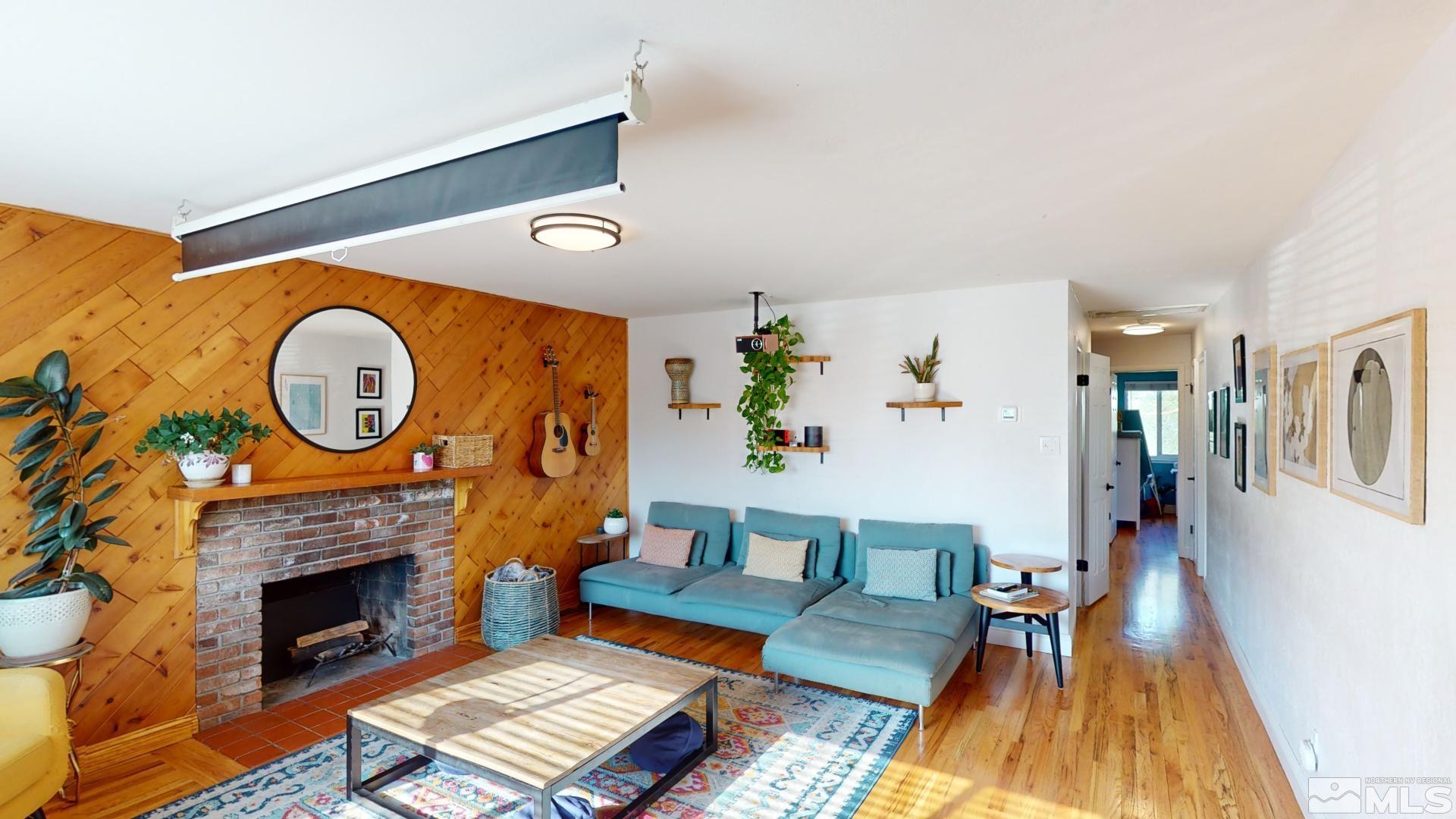 945 Cordone Avenue Reno, NV 89502 - Photo 9 of 33 a living room with furniture a fireplace and a potted plant