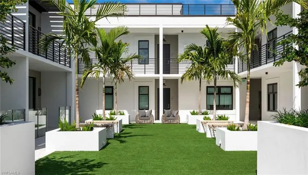 a view of a house with backyard and sitting area