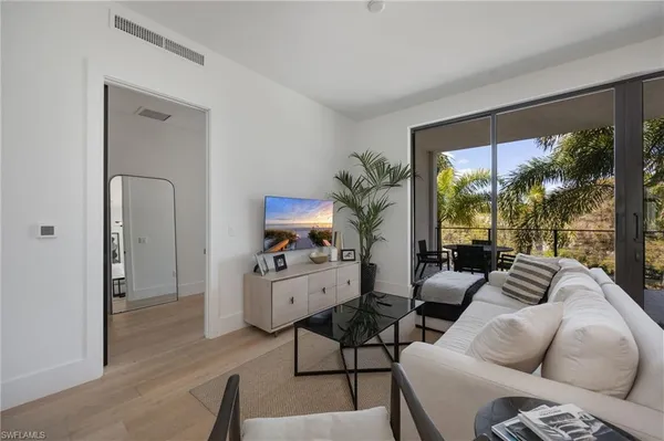 a living room with furniture and a large window