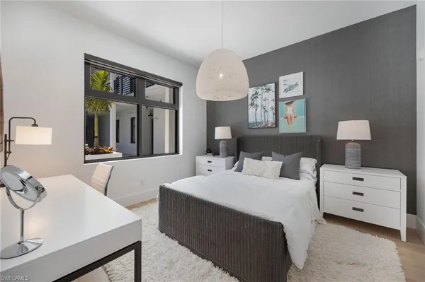 a bedroom with two beds and a dresser