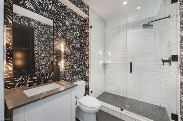 a bathroom with a sink toilet and shower