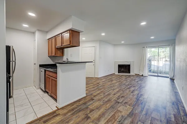 a kitchen with stainless steel appliances granite countertop a refrigerator a stove a sink and a microwave