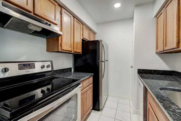 a kitchen with a stove microwave and a refrigerator