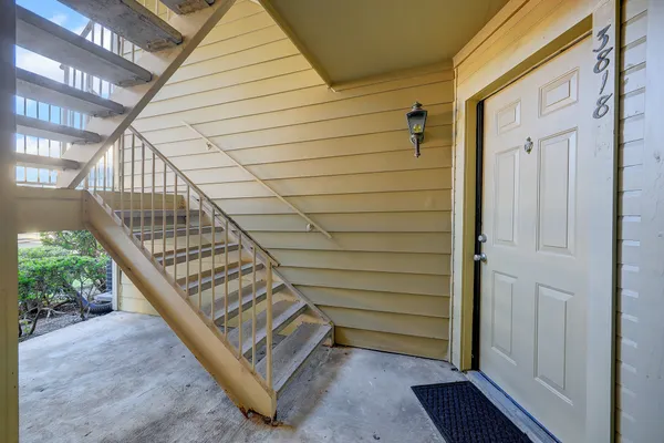 a view of entryway with wooden floor and stairs