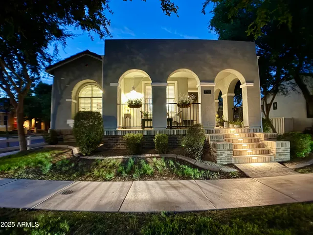 a kitchen with stainless steel appliances a dining table chairs and white cabinets