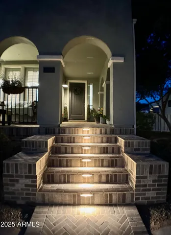 a kitchen with stainless steel appliances kitchen island granite countertop a table chairs sink and cabinets