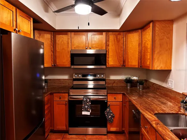 a kitchen with stainless steel appliances granite countertop a stove and a microwave