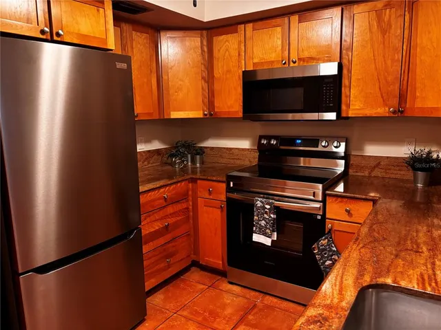 a kitchen with stainless steel appliances a stove and a microwave