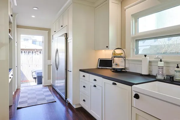 a kitchen with cabinets a sink and appliances