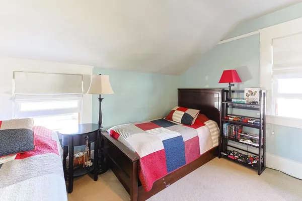 a bedroom with a bed and a lamp