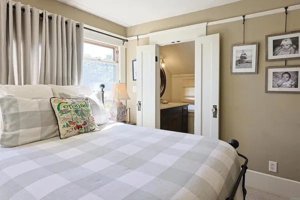 a bedroom with a bed and a window