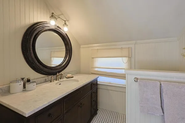 a bathroom with a sink a vanity and a mirror