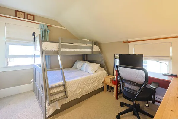 a bedroom with a bed and chair