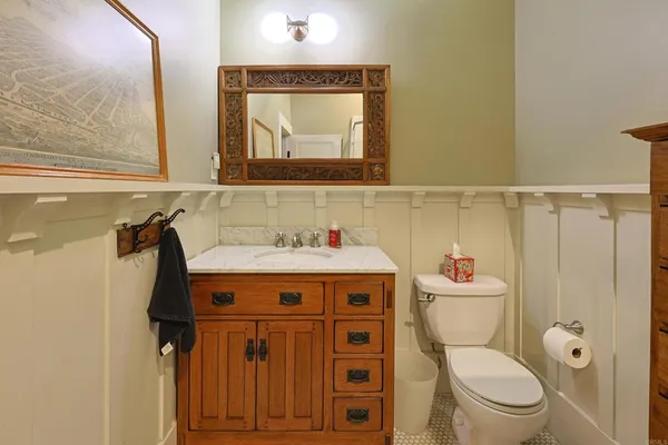 a bathroom with a toilet sink and mirror