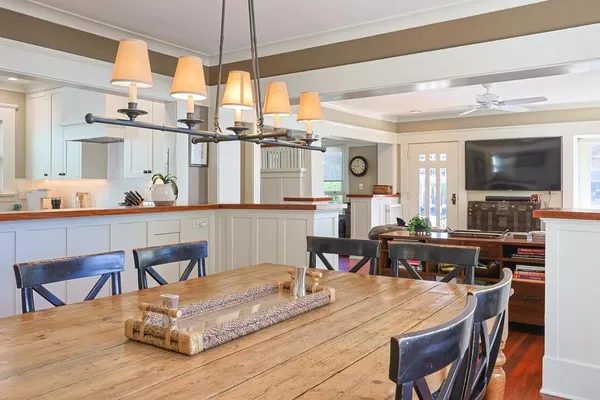 a dining table chairs and a kitchen view
