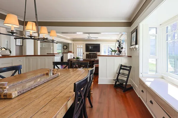 a kitchen with a table chairs stove and cabinets