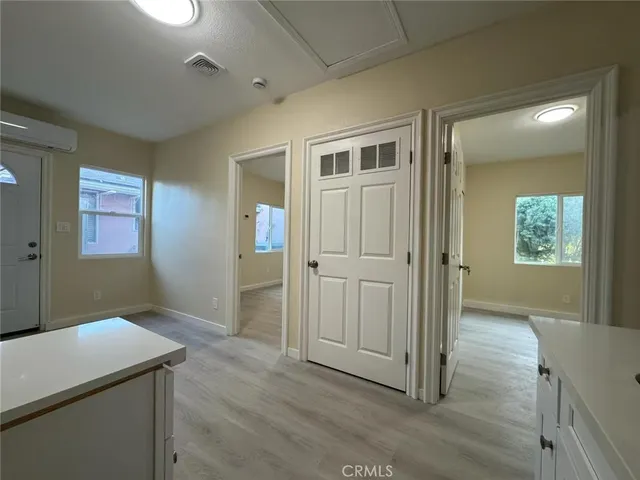 wooden floor in an empty room with a bathroom