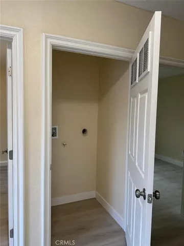 a view of a room with wooden floor