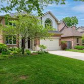 a front view of a house with a garden and plants