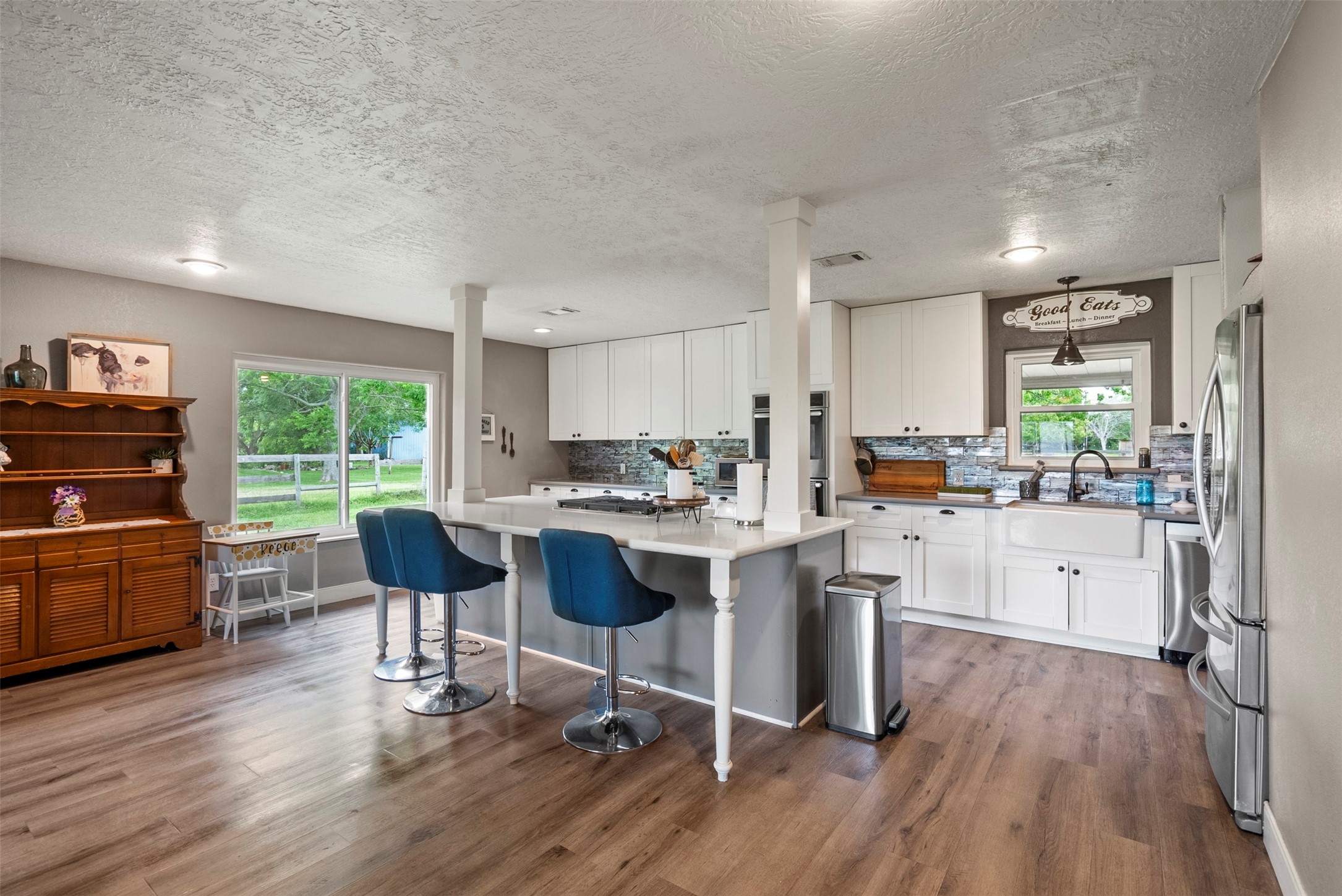 5211 Ghinaudo Road Hitchcock, TX 77563 - Photo 12 of 34 a kitchen with a sink cabinets and wooden floor