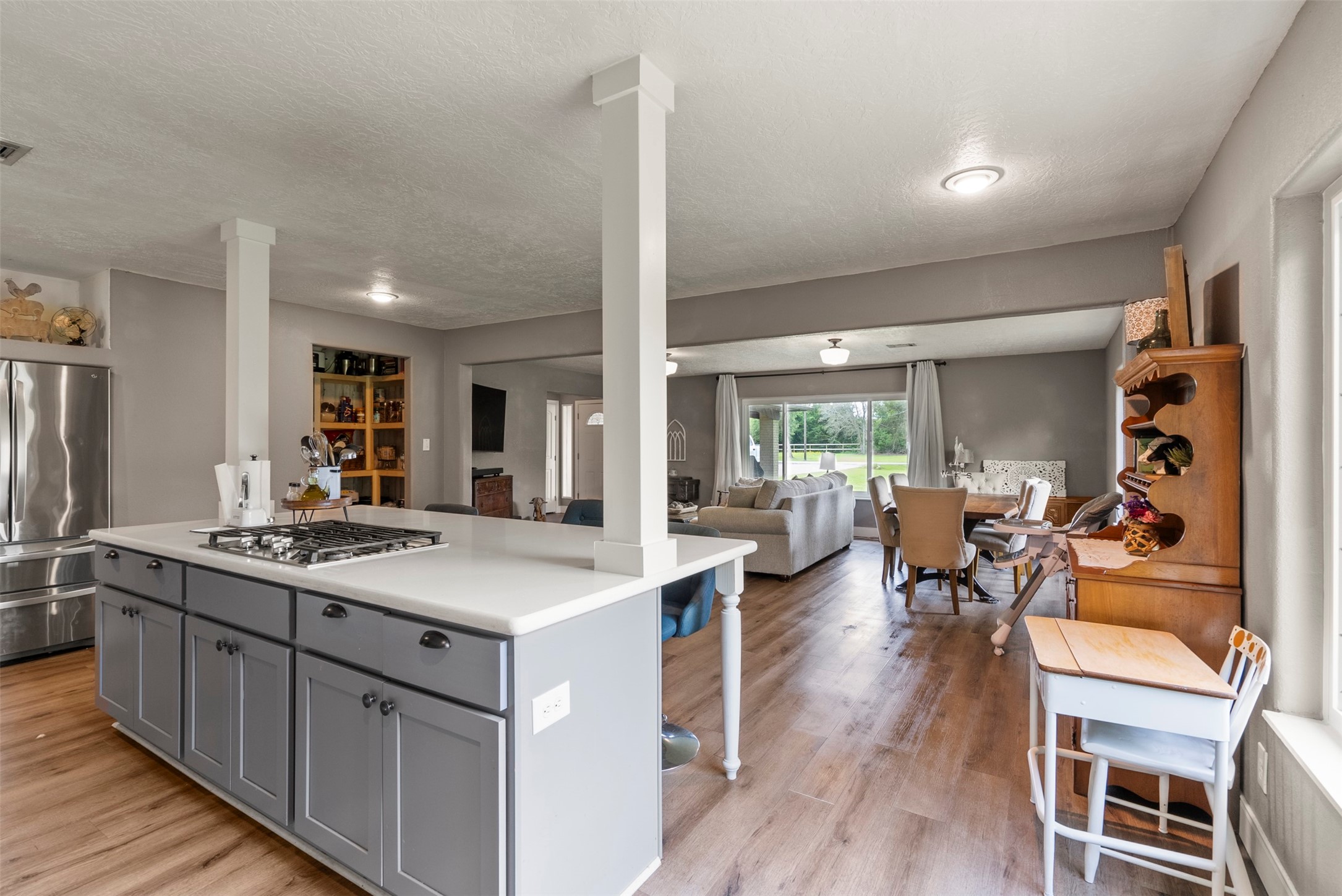 5211 Ghinaudo Road Hitchcock, TX 77563 - Photo 13 of 34 a kitchen with a sink stove and wooden floor