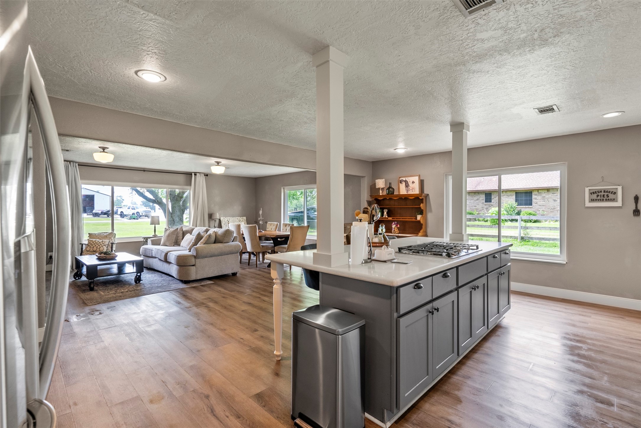5211 Ghinaudo Road Hitchcock, TX 77563 - Photo 15 of 34 a kitchen with sink stove and living room with a large window