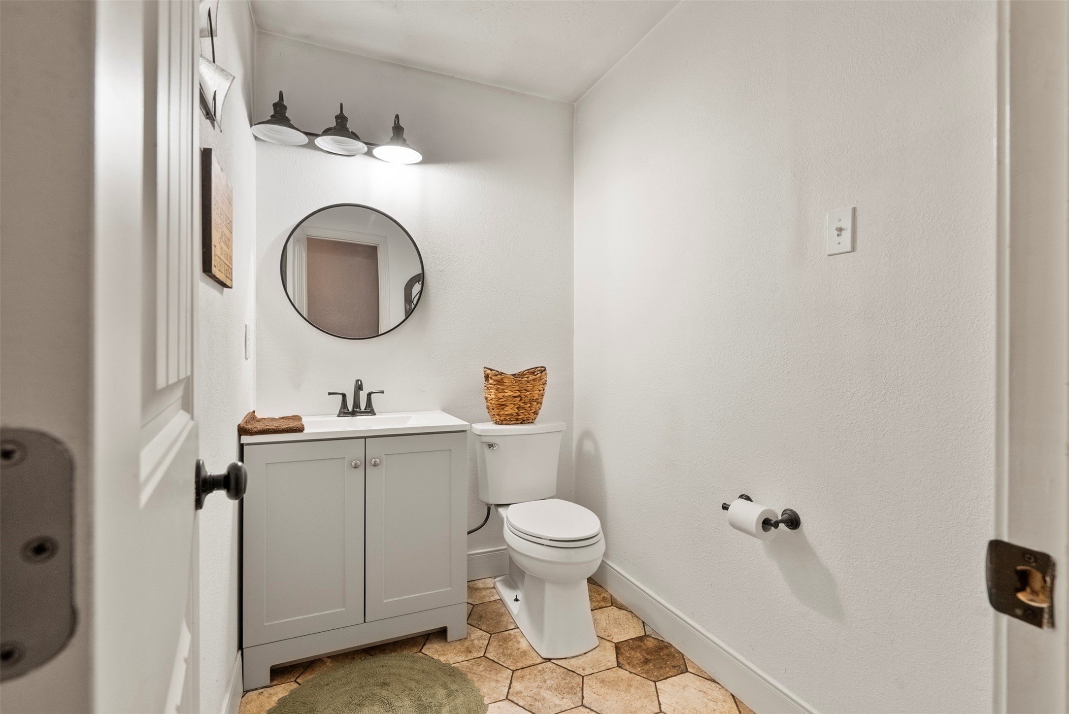 5211 Ghinaudo Road Hitchcock, TX 77563 - Photo 19 of 34 a bathroom with a toilet and a sink