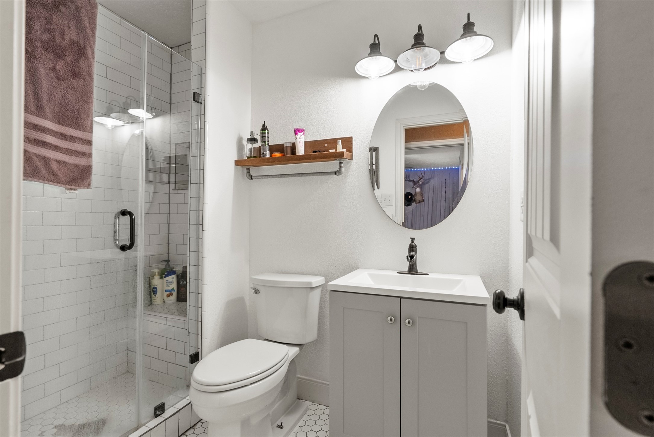 5211 Ghinaudo Road Hitchcock, TX 77563 - Photo 20 of 34 a bathroom with a sink mirror and toilet