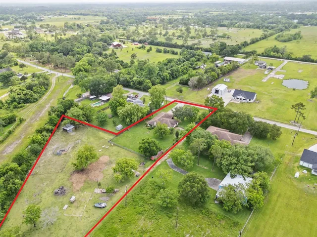 an aerial view of residential houses with outdoor space