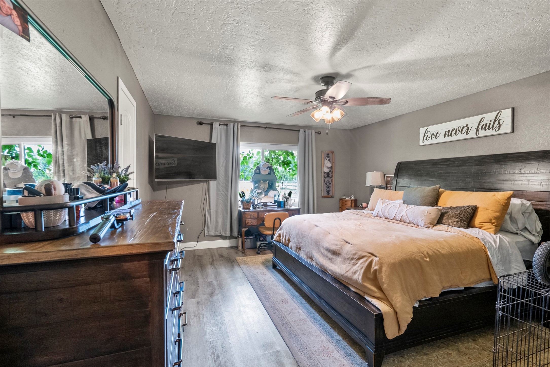 5211 Ghinaudo Road Hitchcock, TX 77563 - Photo 23 of 34 a bedroom with a bed window and a flat screen tv