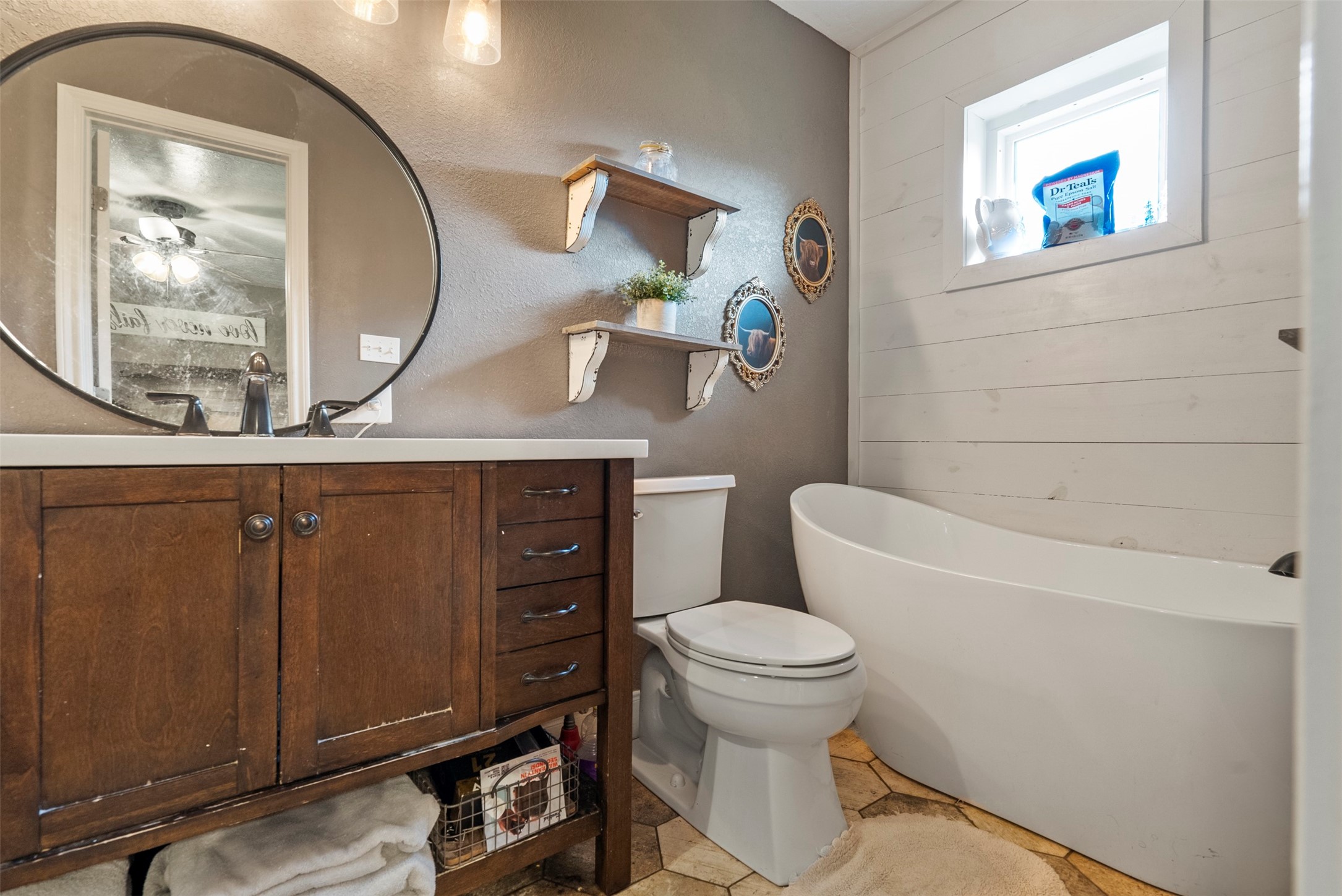 5211 Ghinaudo Road Hitchcock, TX 77563 - Photo 25 of 34 a bathroom with a toilet a sink and mirror