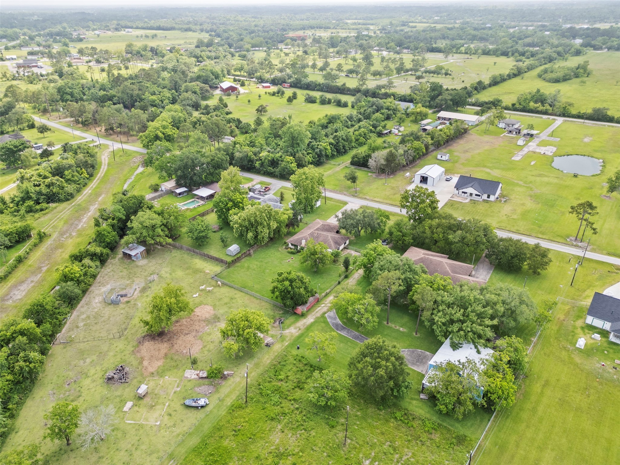 5211 Ghinaudo Road Hitchcock, TX 77563 - Photo 32 of 34 an aerial view of residential houses with outdoor space and trees