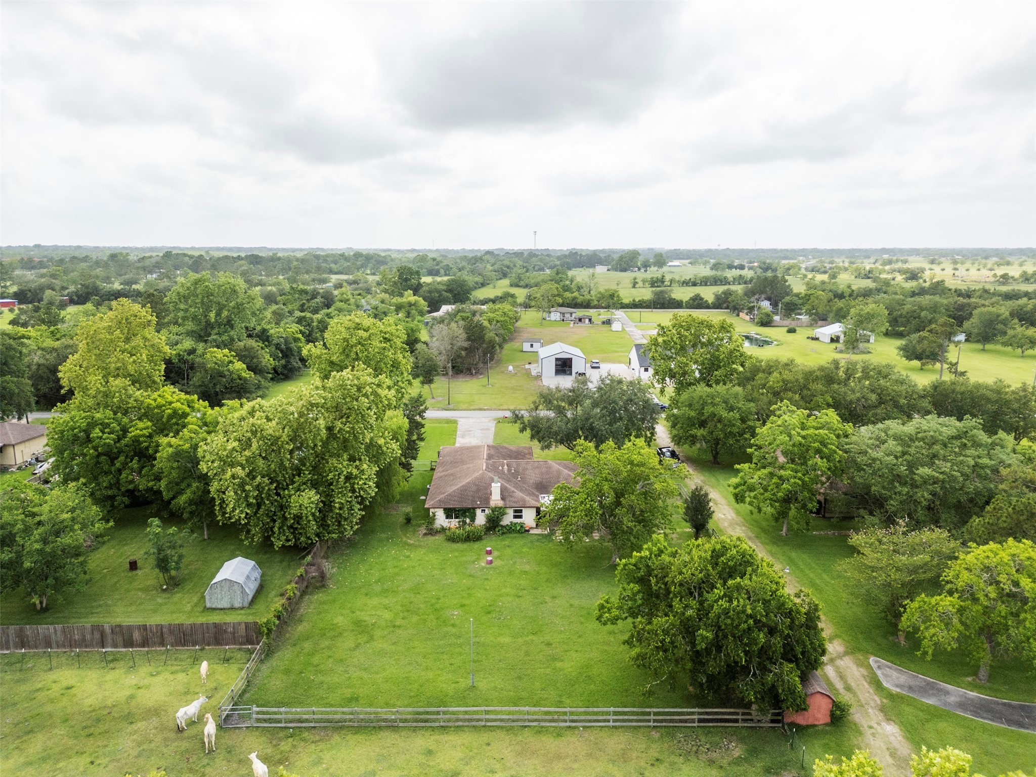 5211 Ghinaudo Road Hitchcock, TX 77563 - Photo 33 of 34 an aerial view of residential houses with outdoor space and trees