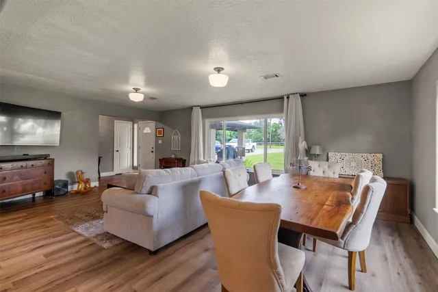 a living room with furniture a table and a large window