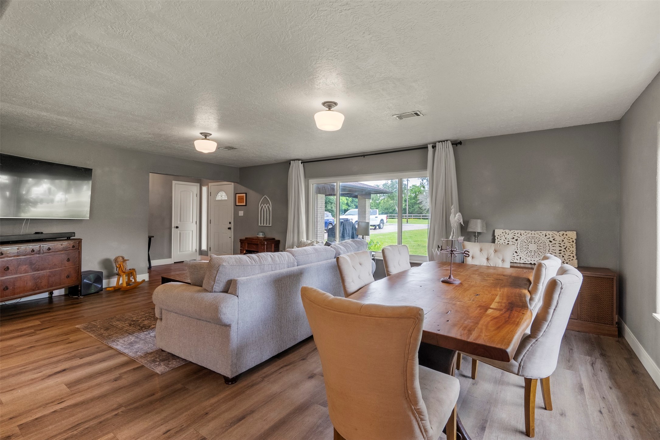 5211 Ghinaudo Road Hitchcock, TX 77563 - Photo 9 of 34 a living room with furniture a table and a large window