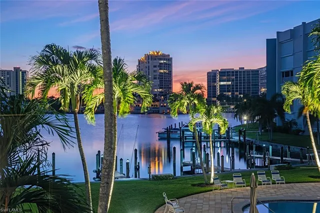 a front view of multiple houses with yard