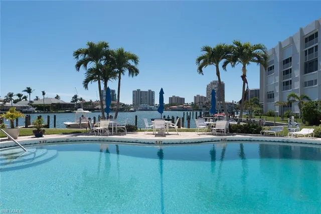 a swimming pool view with a lake view