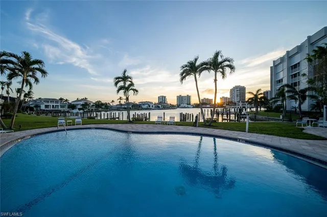 a view of a swimming pool with a table and chairs