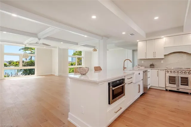 a kitchen with stainless steel appliances granite countertop a stove and a sink