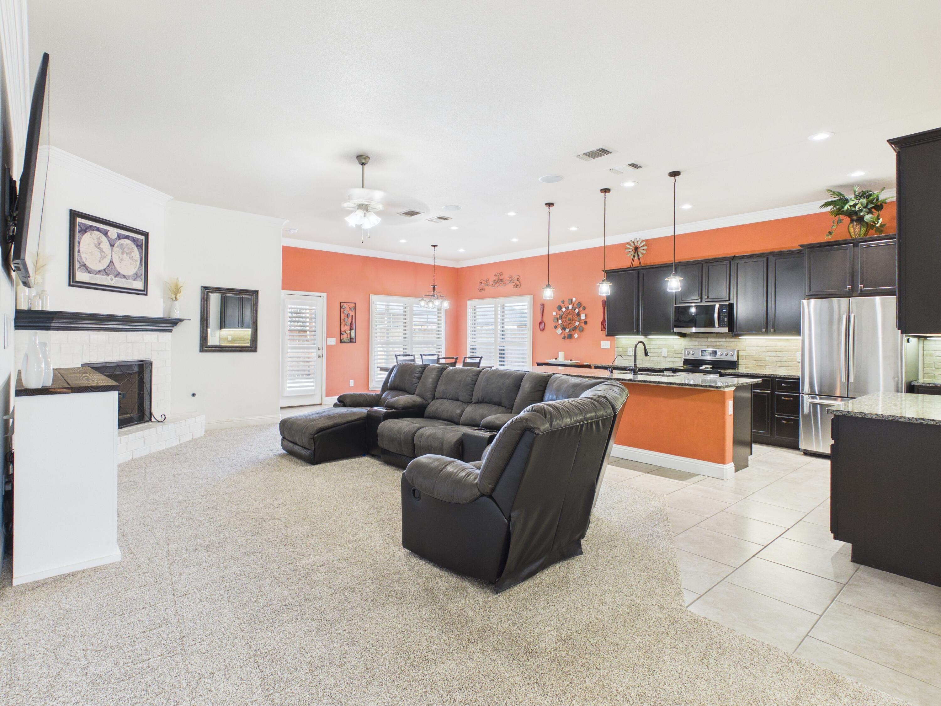 7101 94th Street Lubbock, TX 79424 - Photo 12 of 33 a living room with furniture and kitchen view