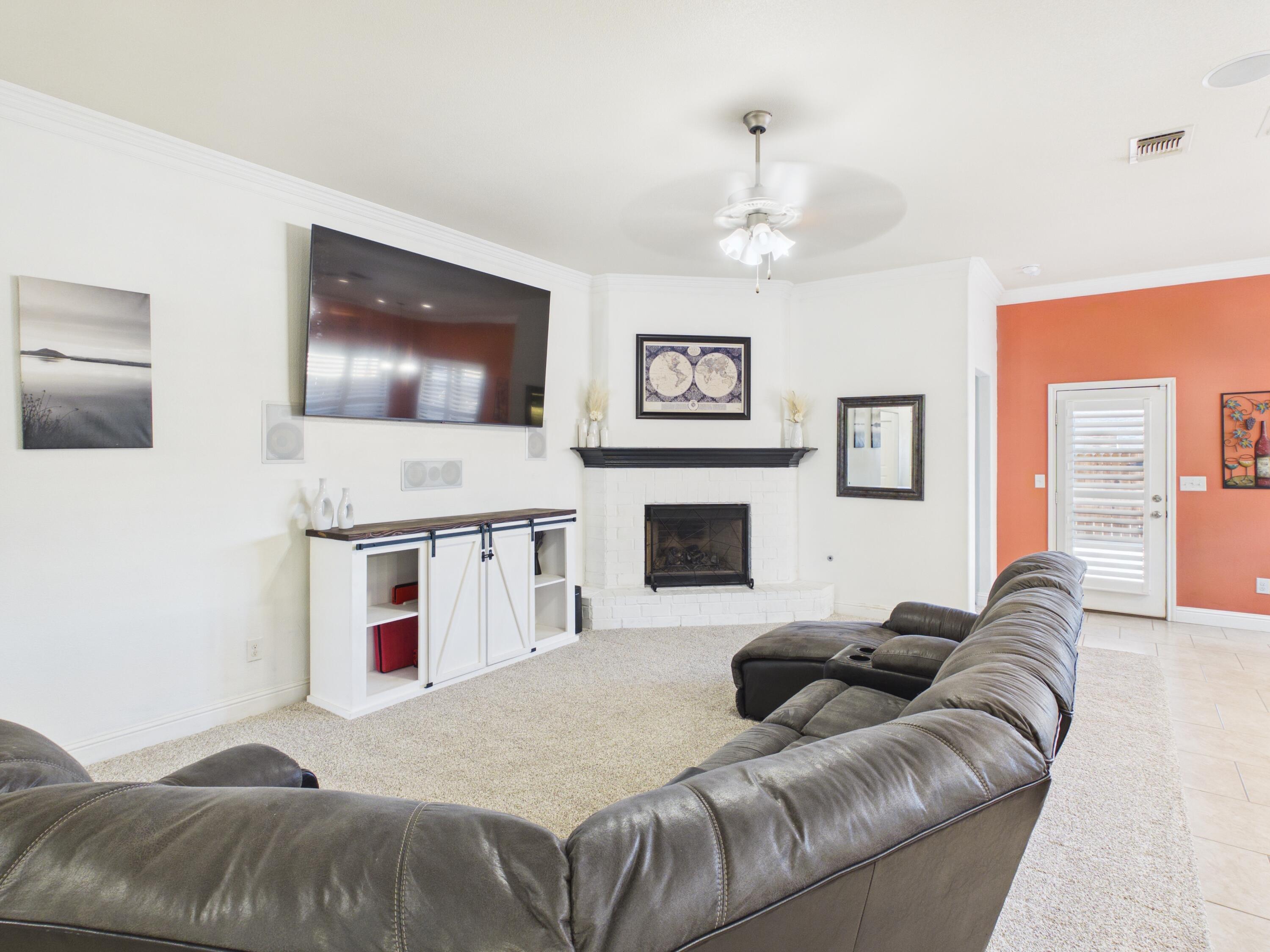 7101 94th Street Lubbock, TX 79424 - Photo 13 of 33 a living room with furniture and a fireplace