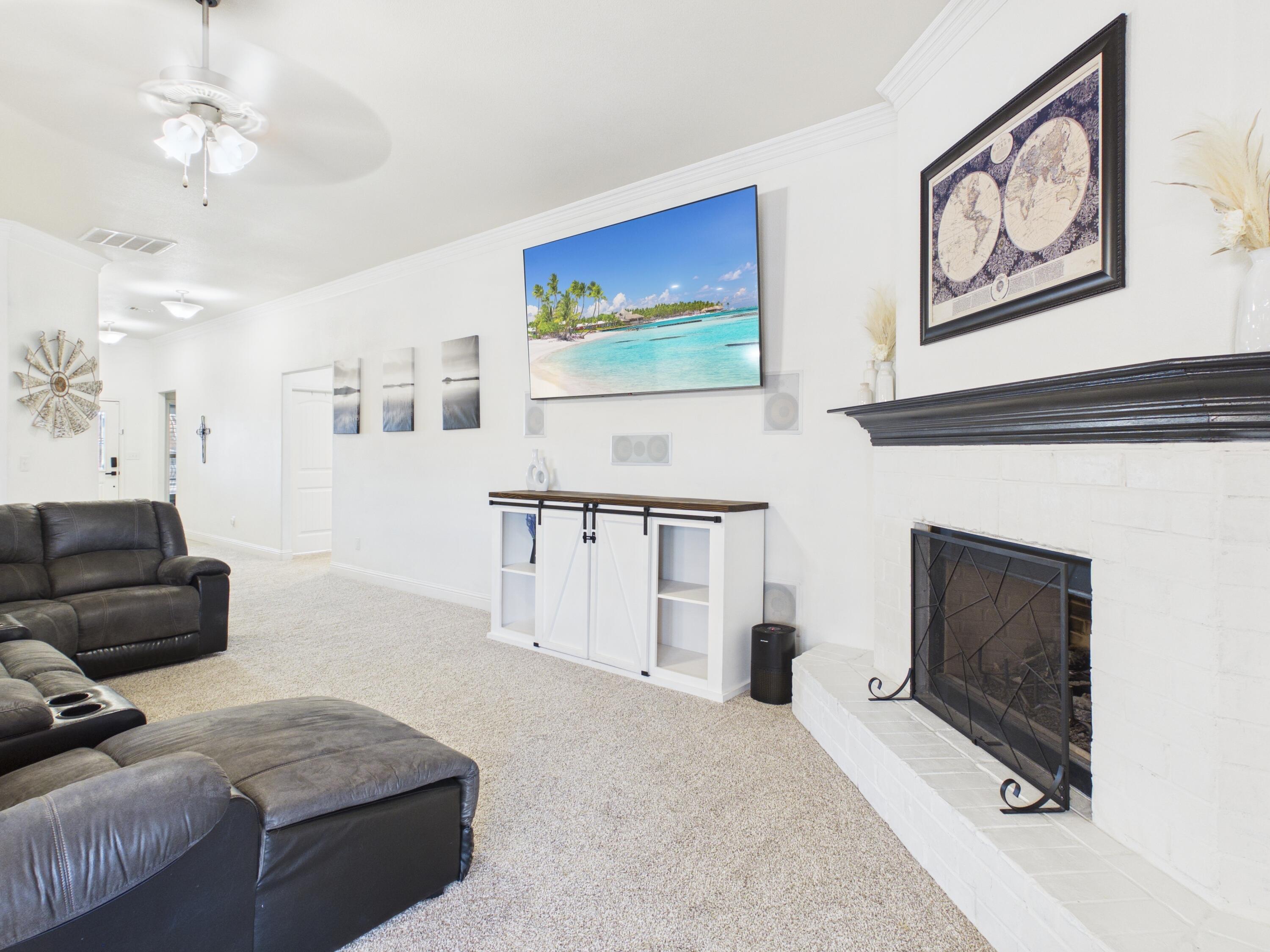 7101 94th Street Lubbock, TX 79424 - Photo 19 of 33 a living room with furniture and a fireplace