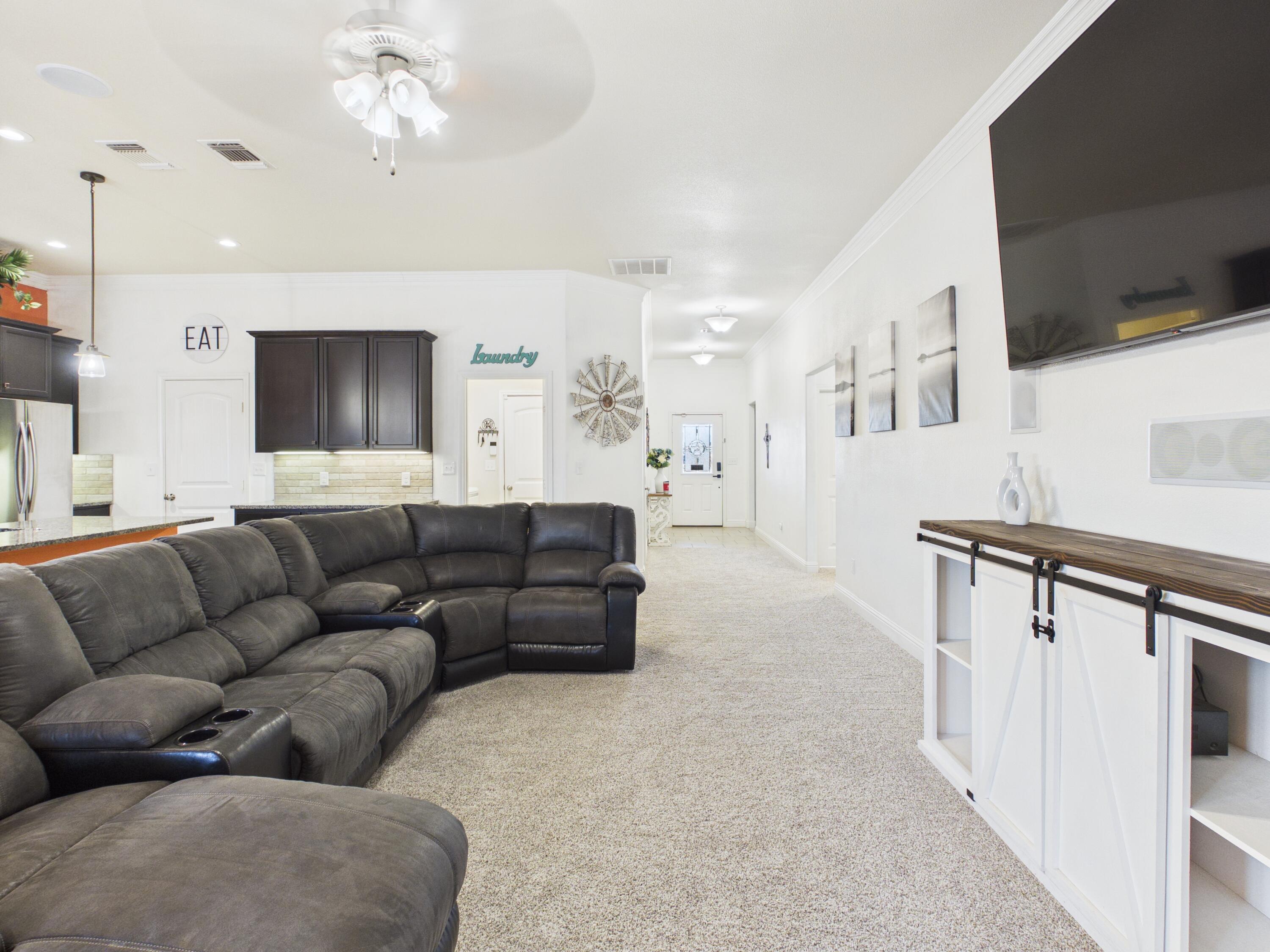 7101 94th Street Lubbock, TX 79424 - Photo 20 of 33 a living room with furniture and a flat screen tv