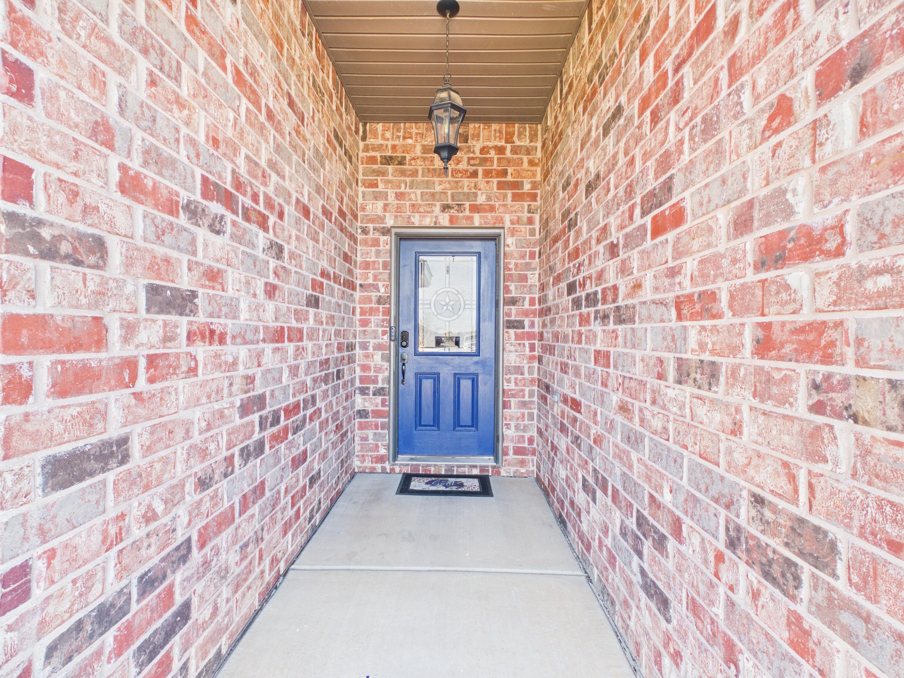 7101 94th Street Lubbock, TX 79424 - Photo 2 of 33 a view of entryway with brick walls