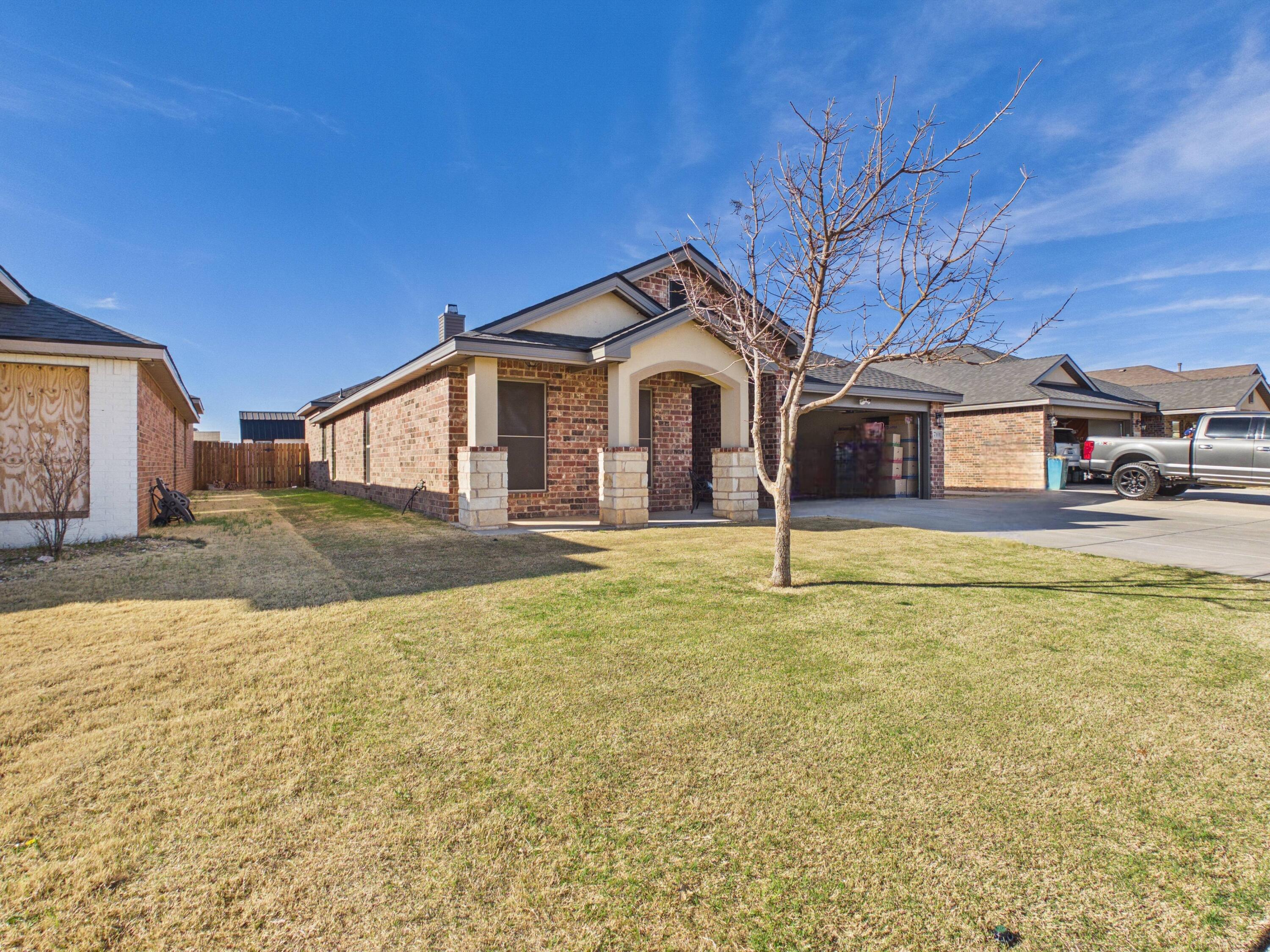 7101 94th Street Lubbock, TX 79424 - Photo 32 of 33 a front view of a house with a yard
