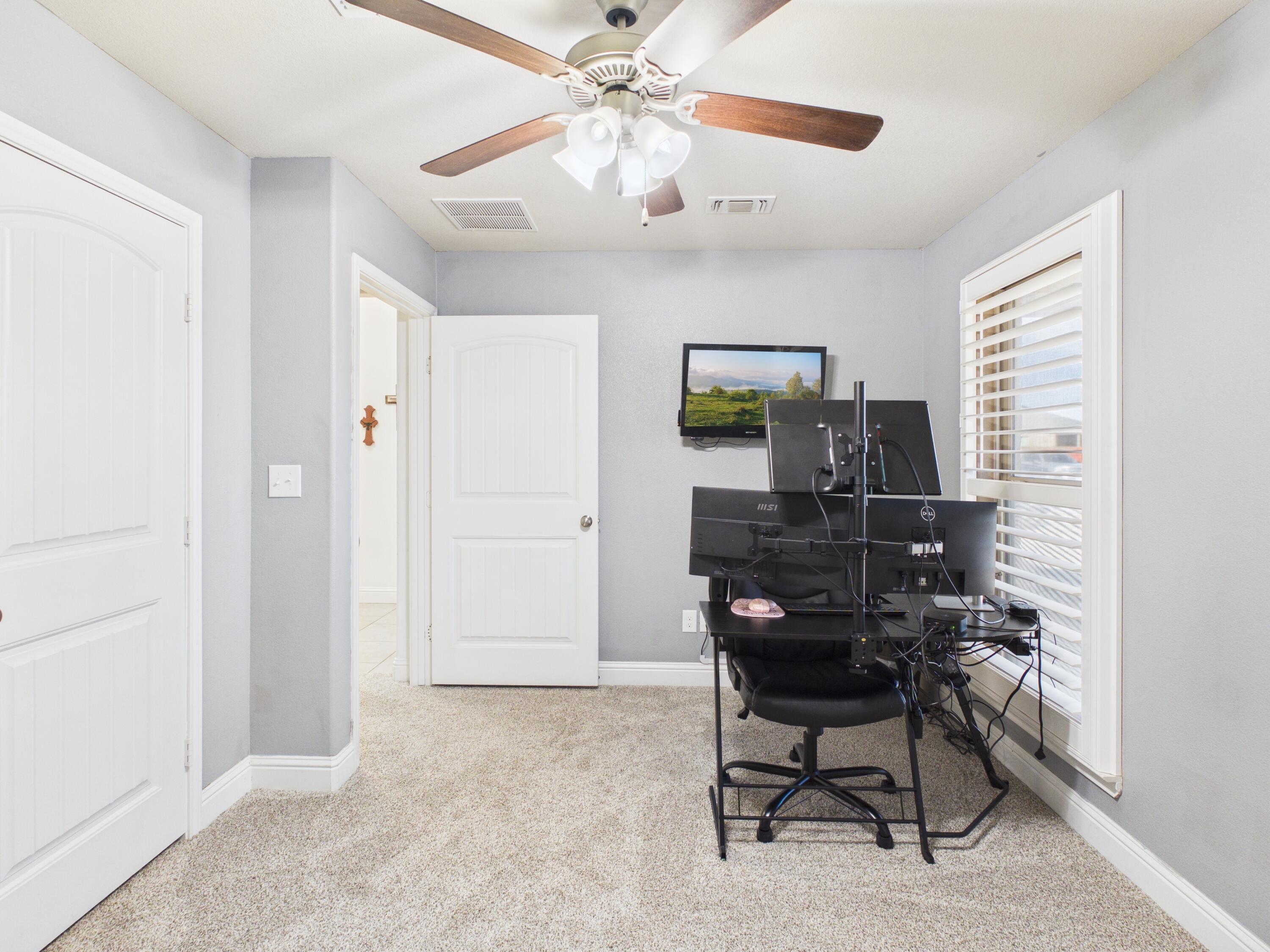 7101 94th Street Lubbock, TX 79424 - Photo 6 of 33 a view of a workspace with furniture and a window
