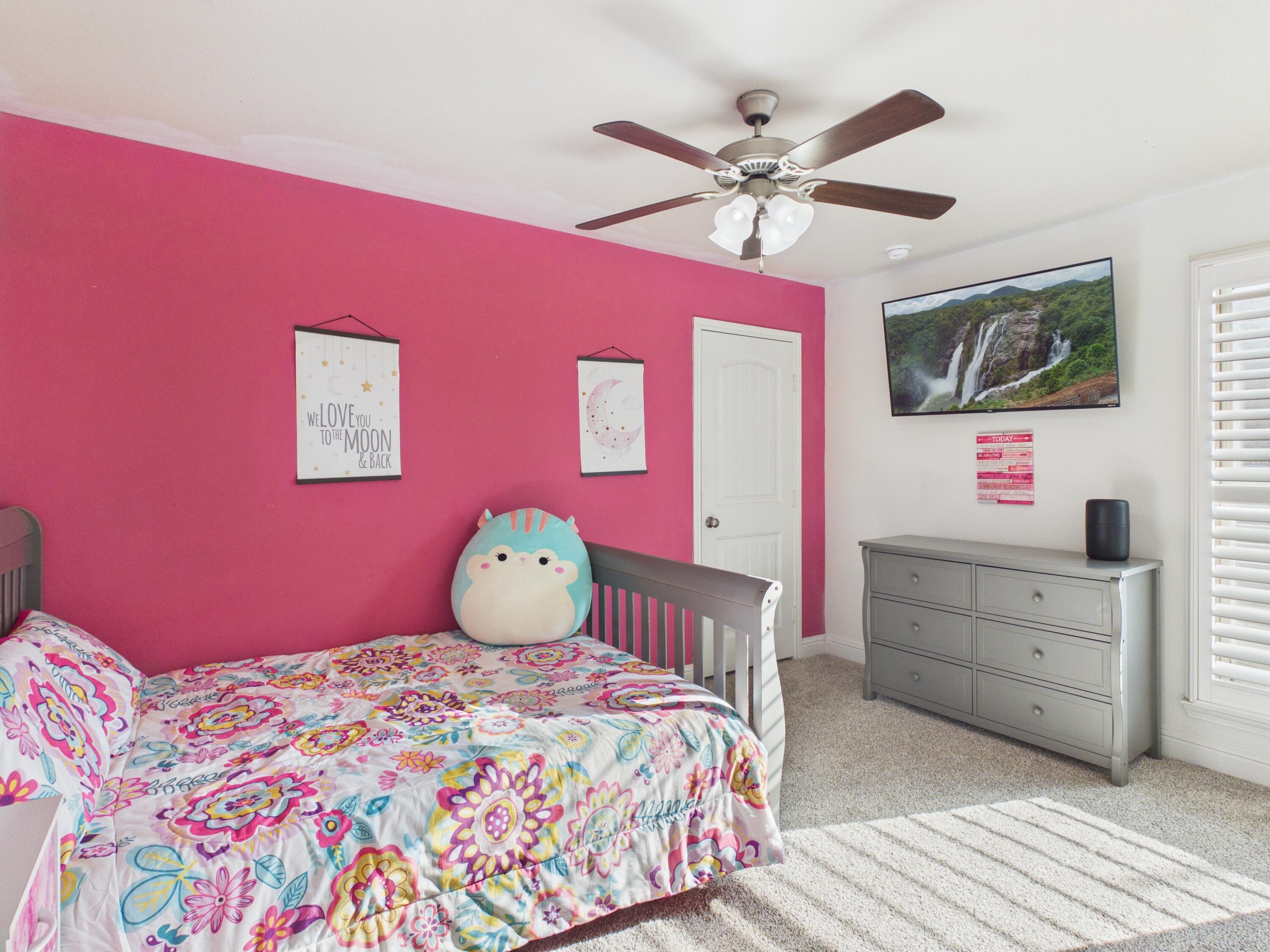 7101 94th Street Lubbock, TX 79424 - Photo 7 of 33 a bedroom with a bed and a chandelier