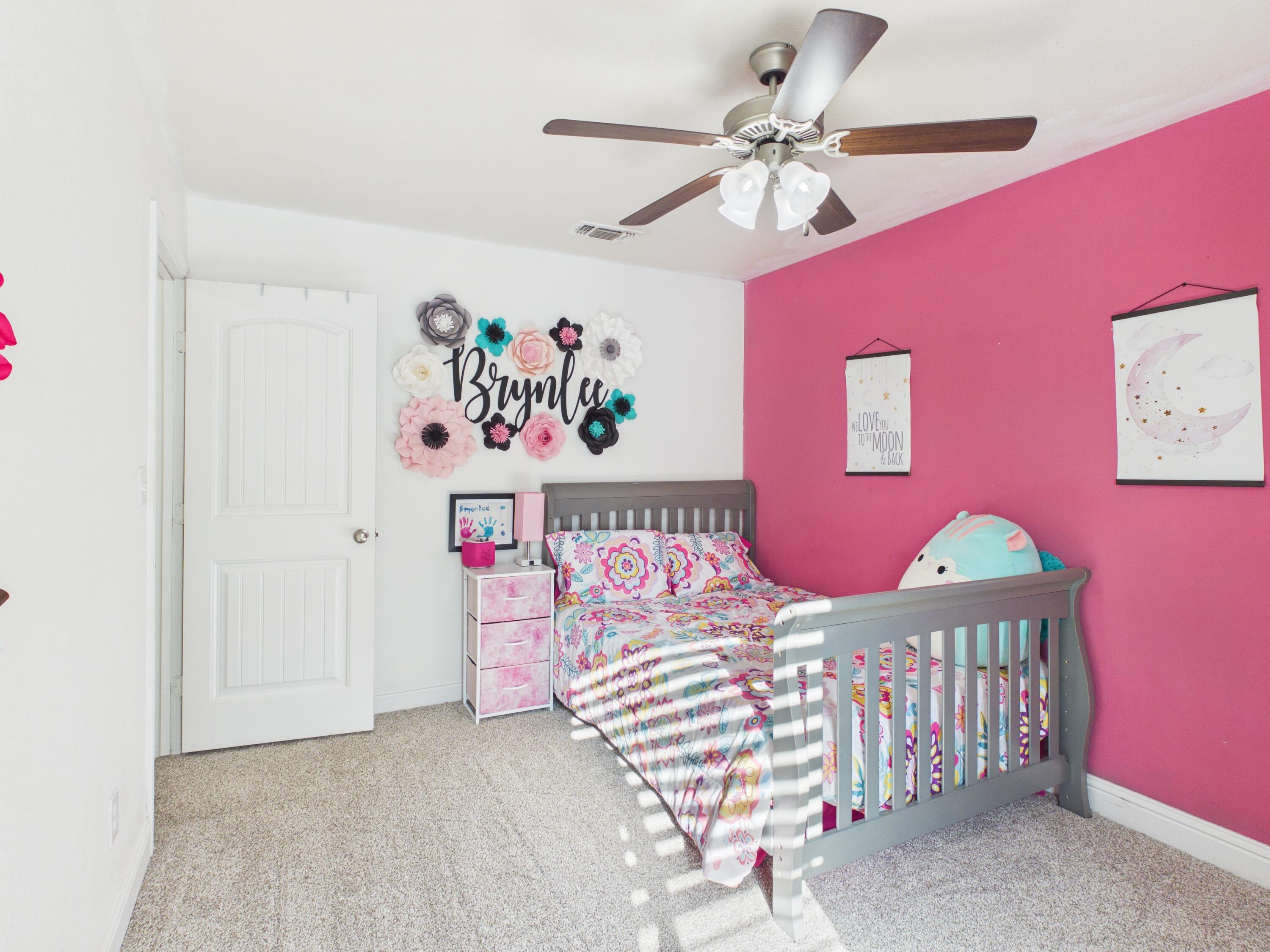 7101 94th Street Lubbock, TX 79424 - Photo 8 of 33 a bedroom with furniture and a chandelier