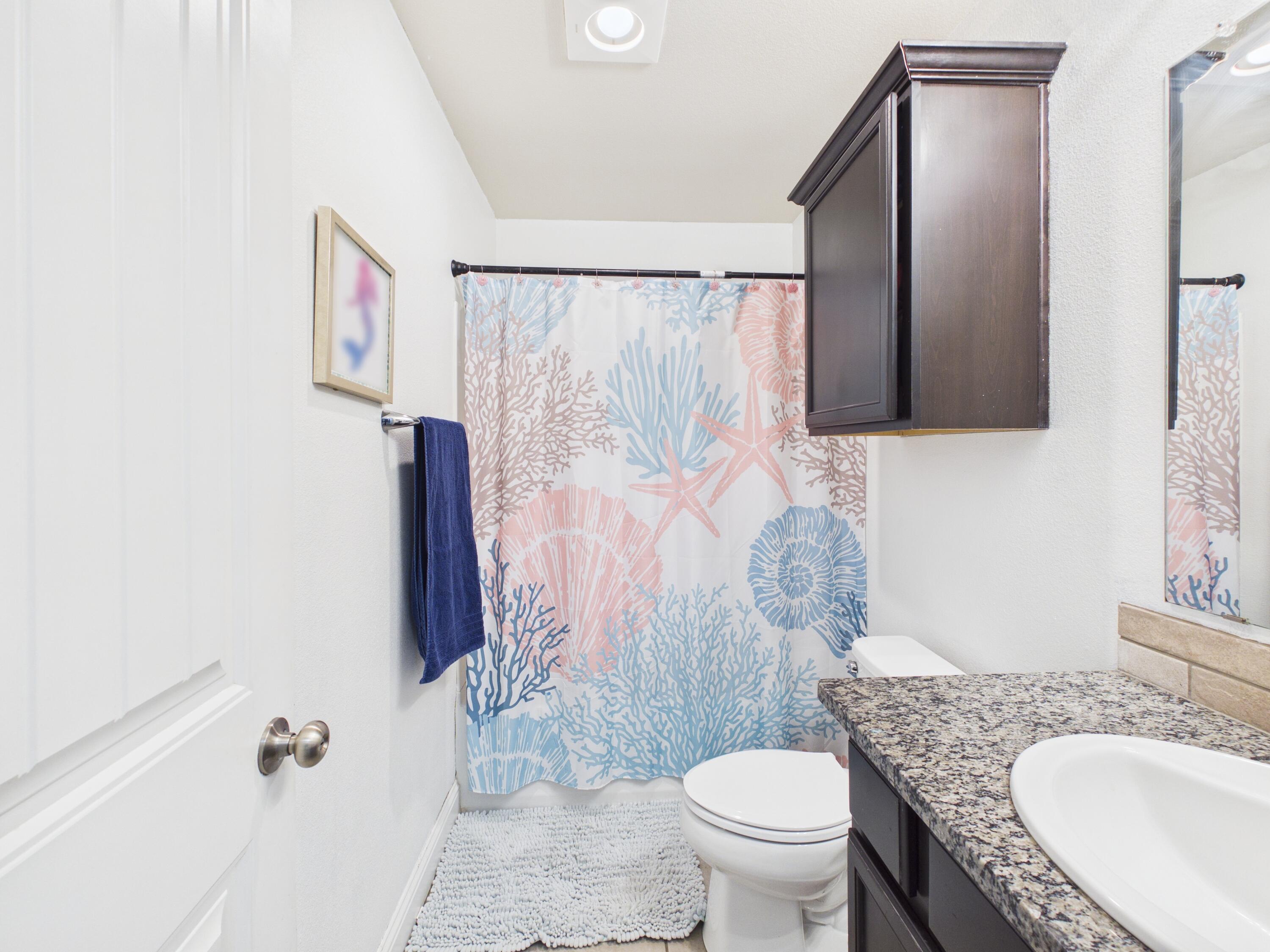 7101 94th Street Lubbock, TX 79424 - Photo 9 of 33 a bathroom with a granite countertop sink toilet and shower