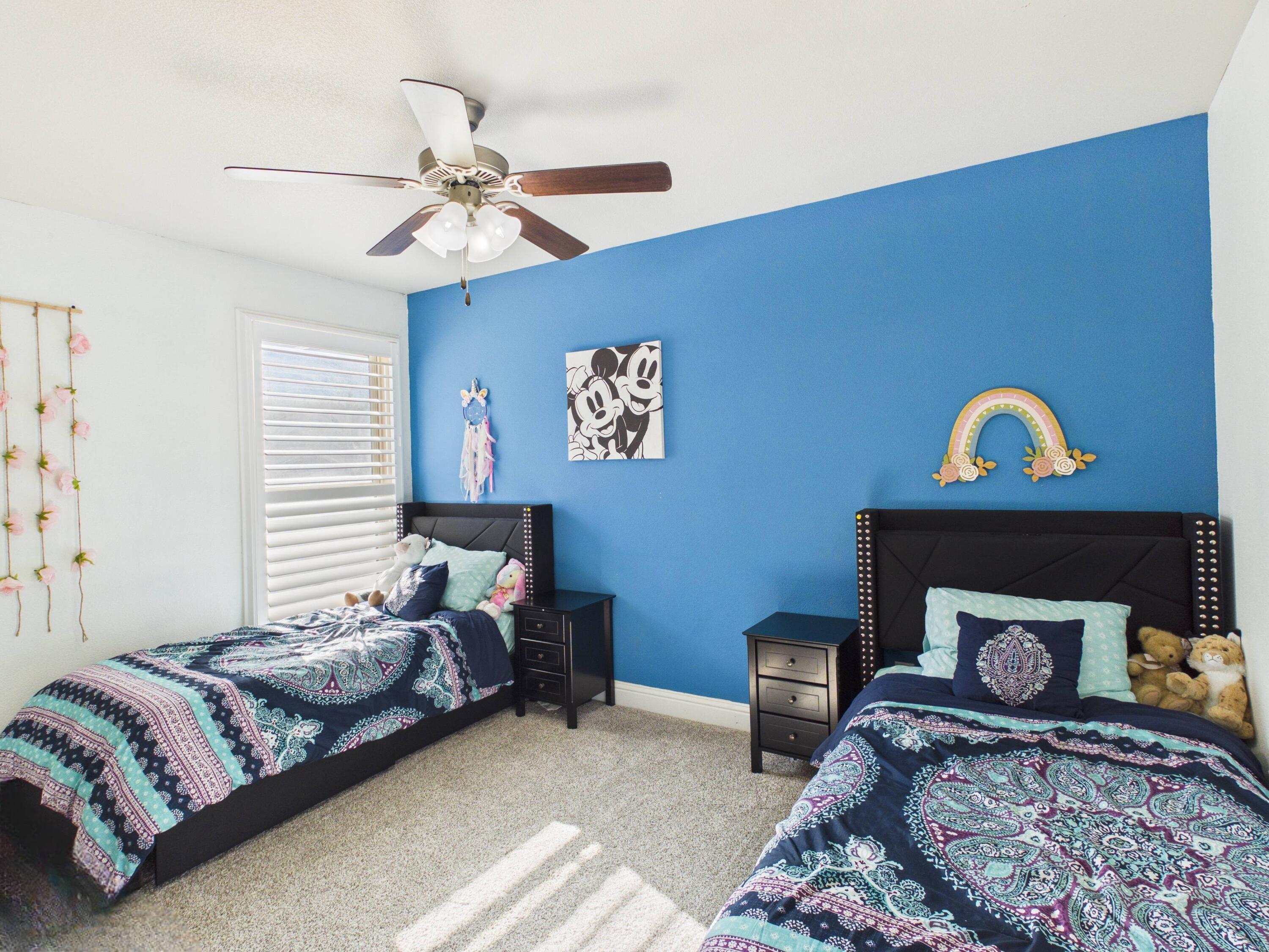 7101 94th Street Lubbock, TX 79424 - Photo 10 of 33 a bedroom with a bed and a chandelier